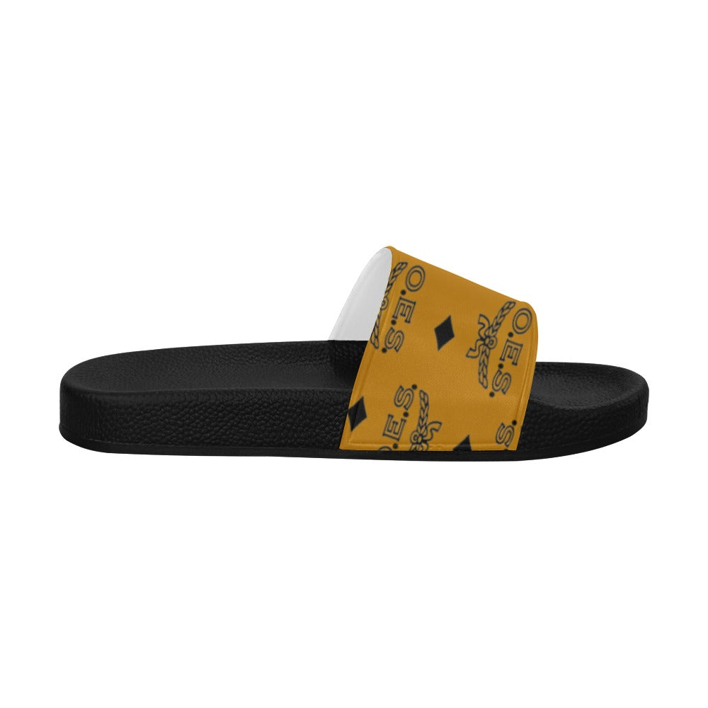 Black slide sandal with a yellow and black patterned strap on a white background