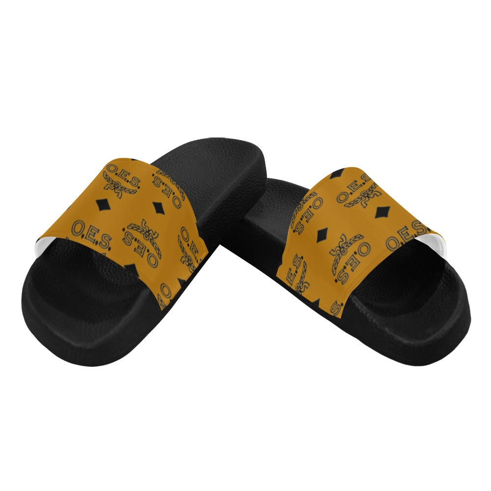 Black slides with yellow straps featuring a logo on a white background