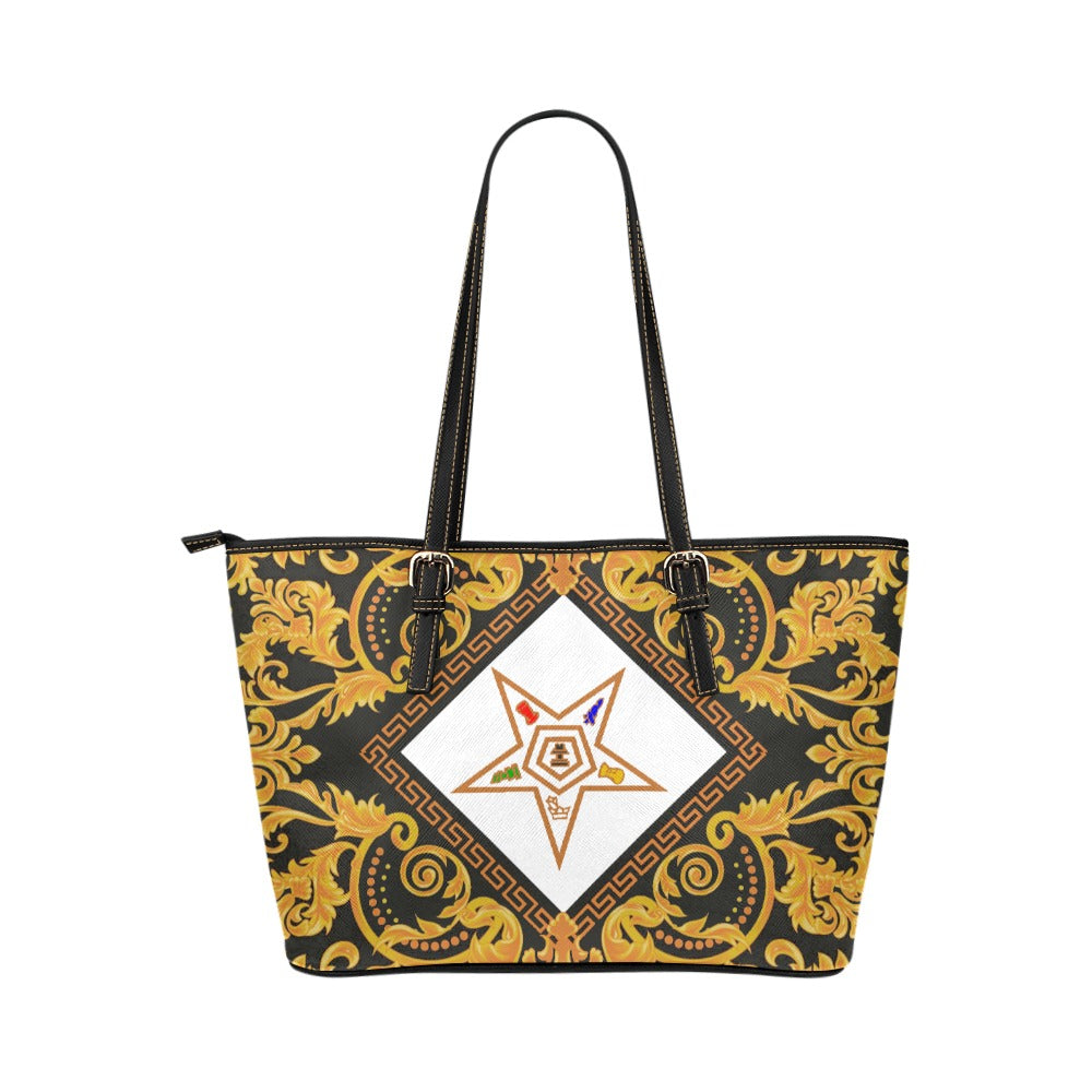 Designer handbag with gold and black pattern on a white background