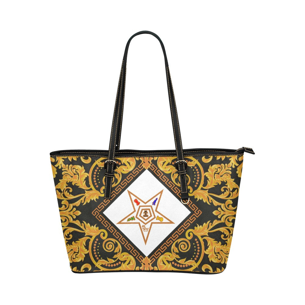 Tote bag with gold baroque pattern and central logo on a white background